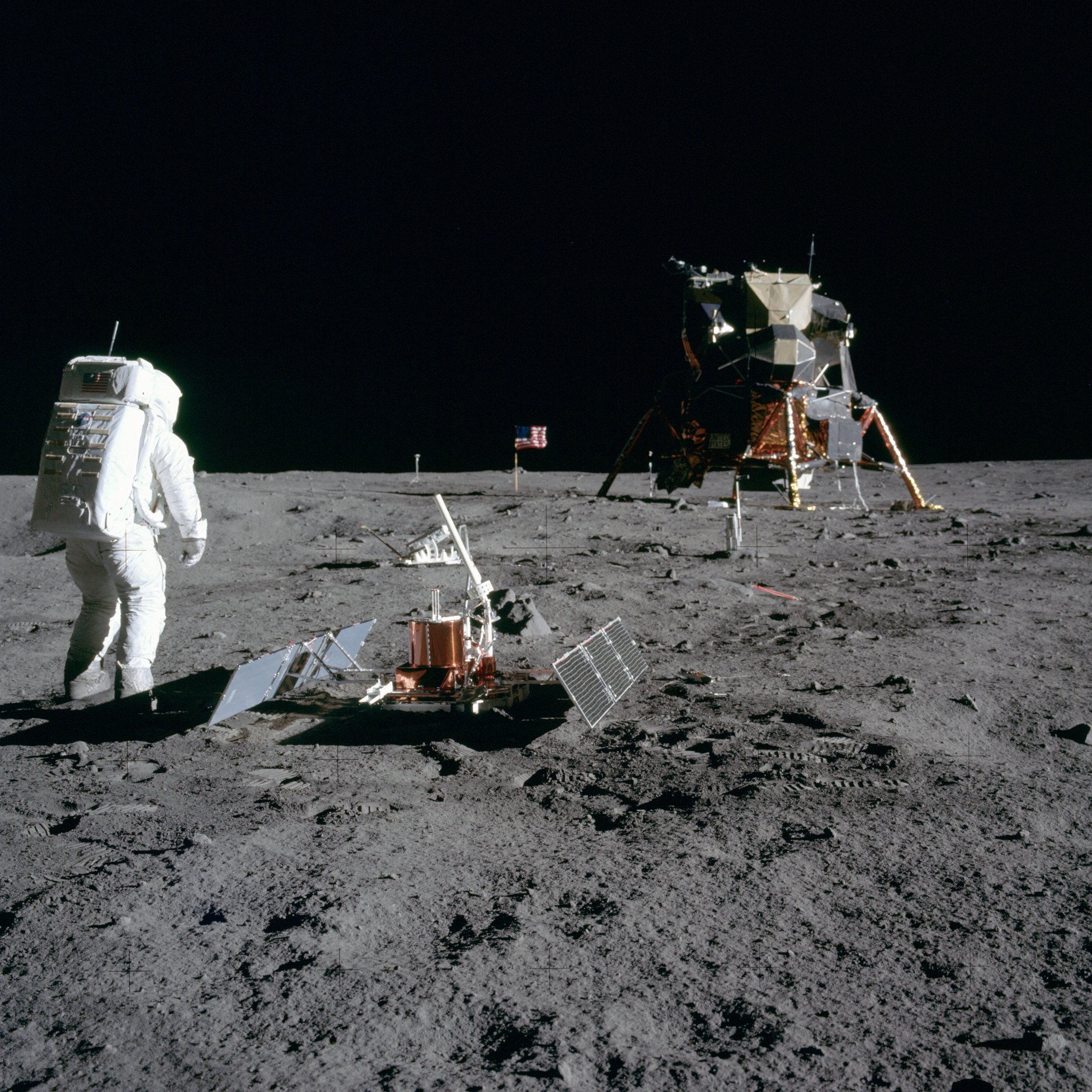 A photo of the deployed PSEP equipment, showing Buzz Aldrin and the Lunar Exploration Module in the background.