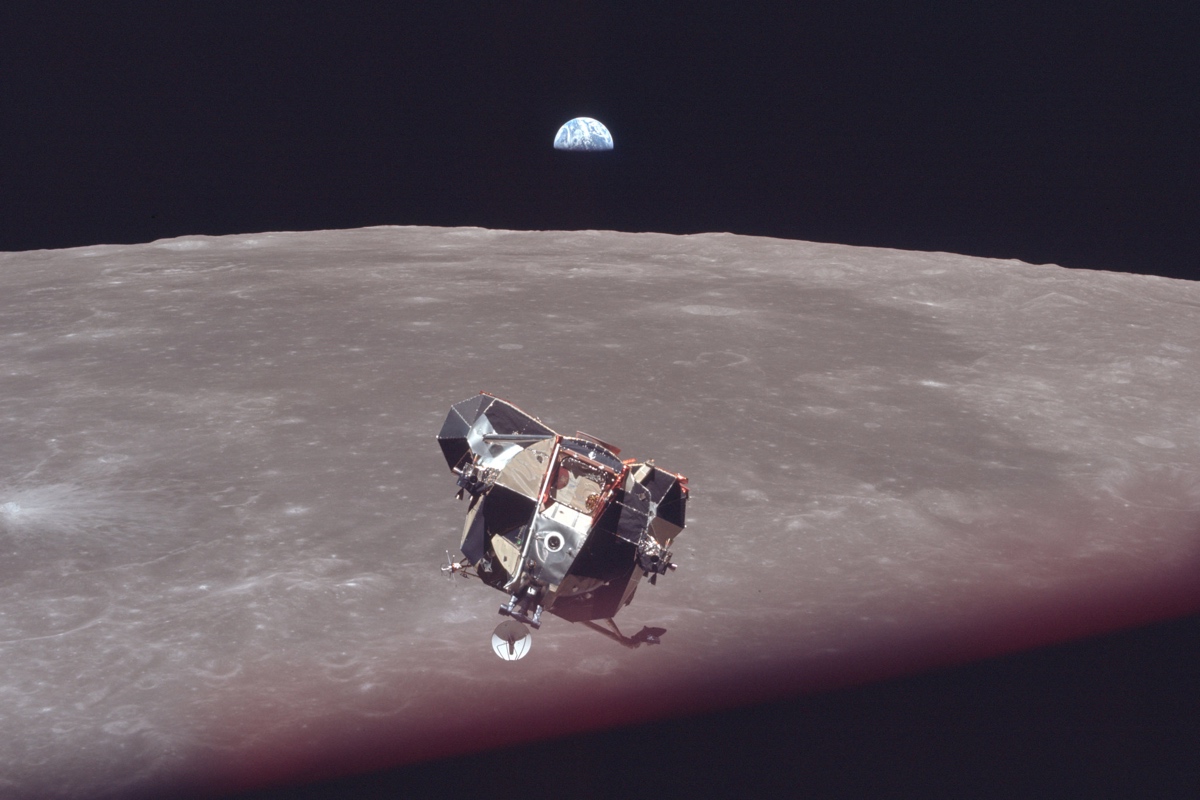 Apollo 11 module on its way to the lunar surface. Earth in the background.